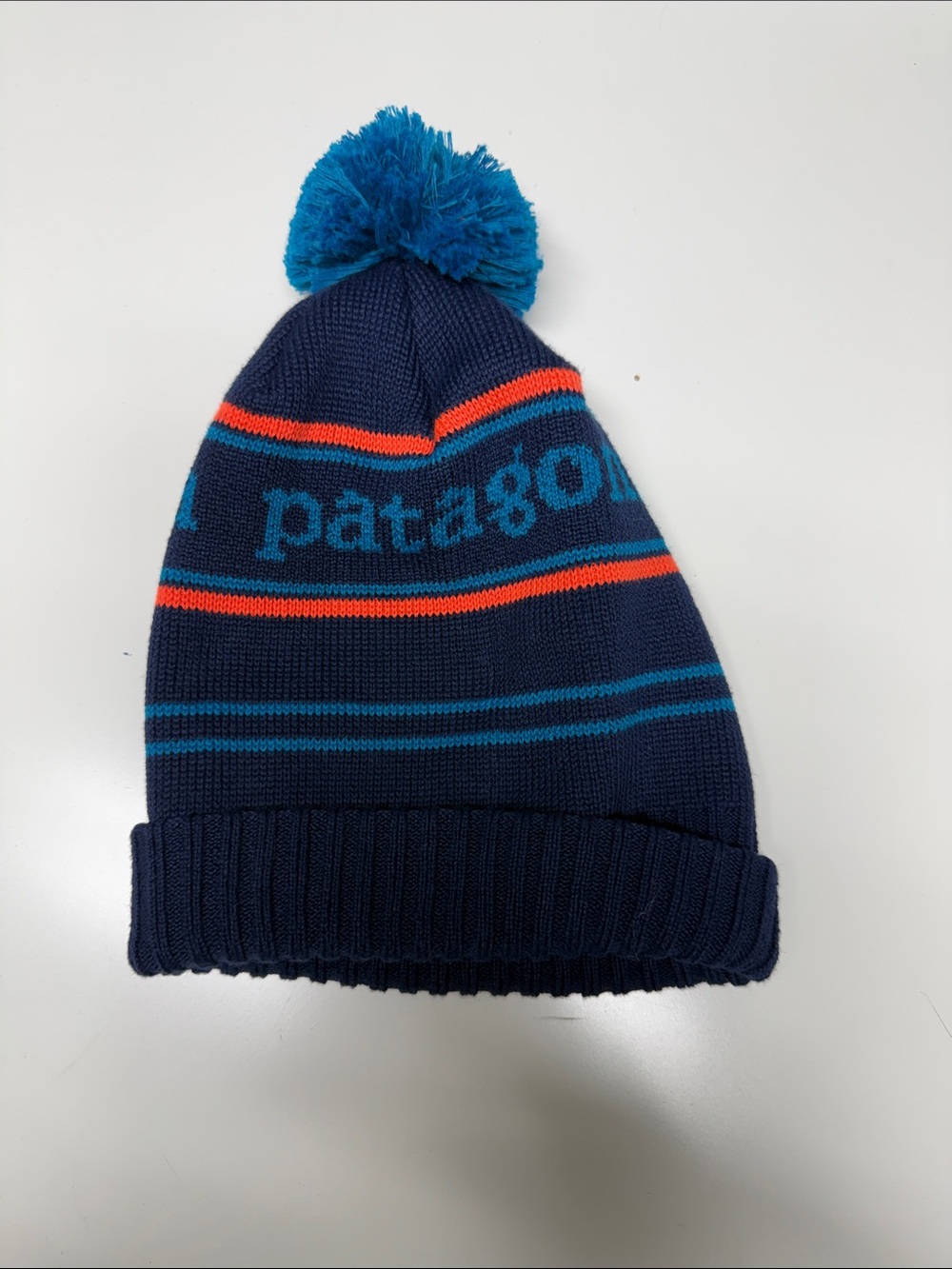 Kids Patagonia Navy Beanie with Teal Pom and Orange Stripe Accents